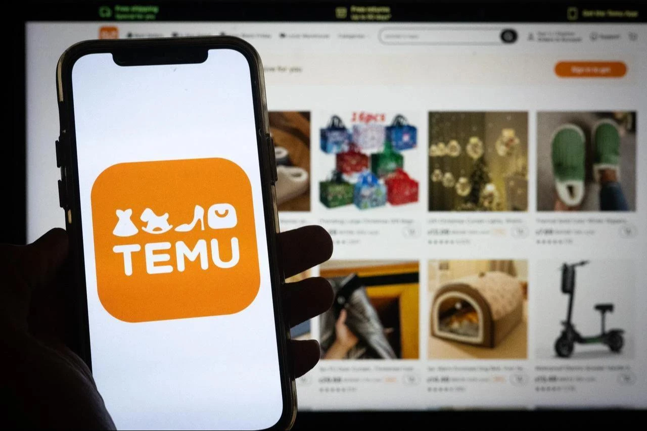 Photo illustration shows the Temu shopping app logo displayed on a smartphone, with the platform’s online marketplace in the background. (Adobe Stock Photo)
