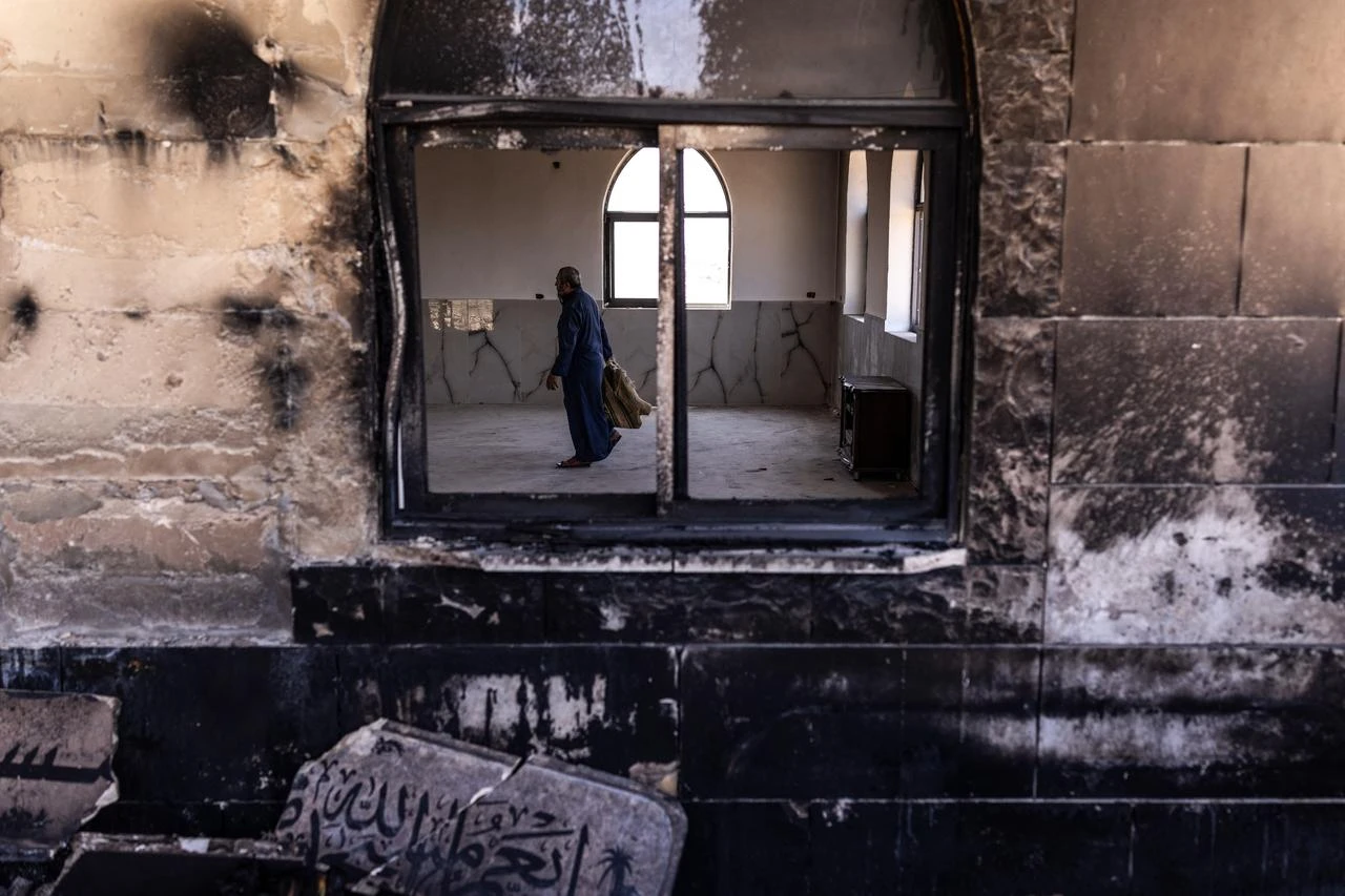 A Palestinian man prepares to pray at a mosque allegedly burned by Israeli settlers in the village of Qusra, south of Nablus in the Israeli-occupied West Bank, July 26, 2026. (AFP Photo)