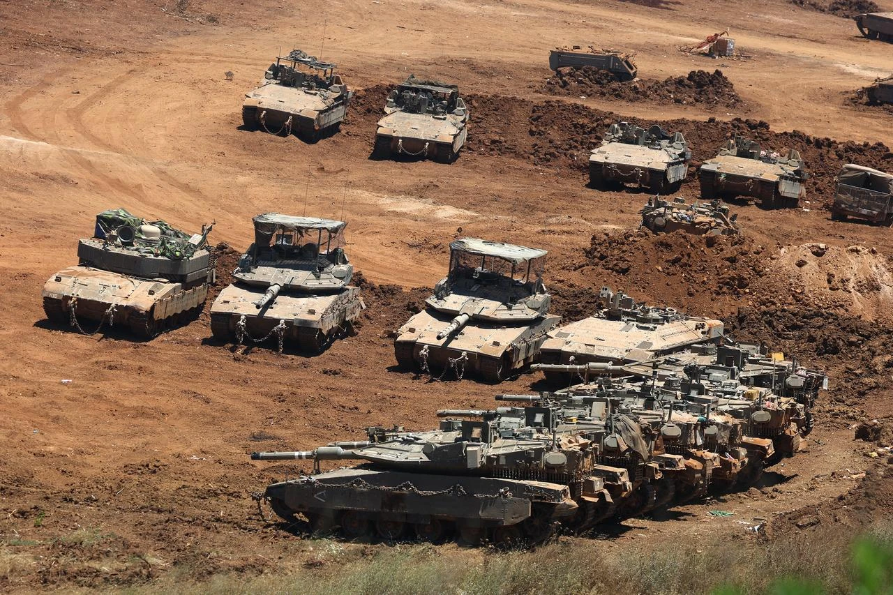 This picture taken from a position in the Upper Galilee in northern Israel shows Israeli army tanks positioned along the Israel-Lebanon border, July 1, 2026. (AFP Photo)