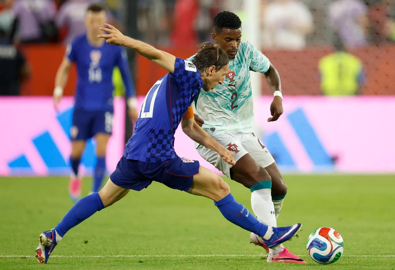 Croatia's midfielder #10 Luka Modric and Portugal's defender #02 Nelson Semedo fight for the ball during the 2026 World Cup round of 32 football match between Portugal and Croatia at the Toronto Stadium in Toronto, July 2, 2026.  (AFP Photo)