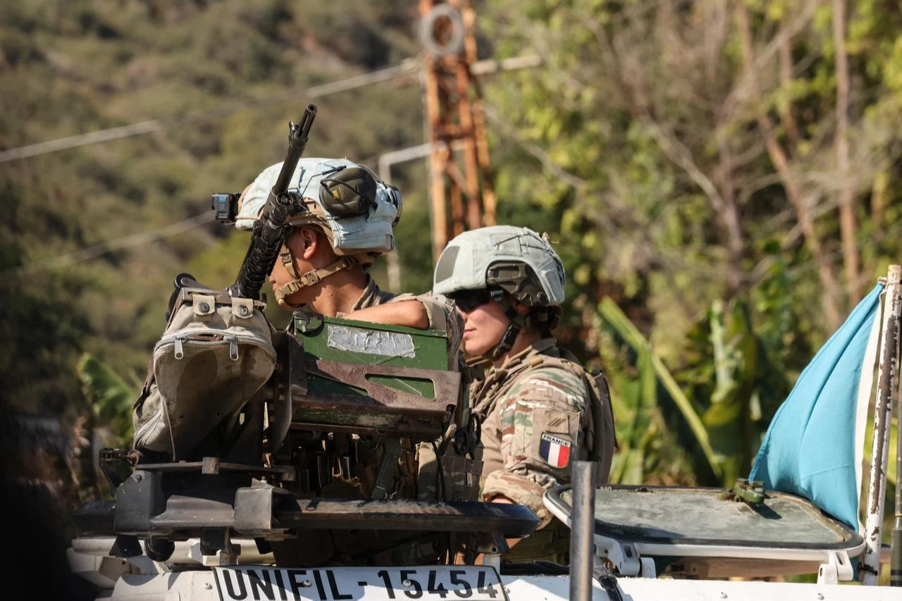 A photograph taken during a media tour shows a French peacekeeper (R) of the United Nations Interim Force In Lebanon (UNIFIL) patrolling near the southern Lebanese village Biout es Sayed, July 20, 2026. (AFP Photo)