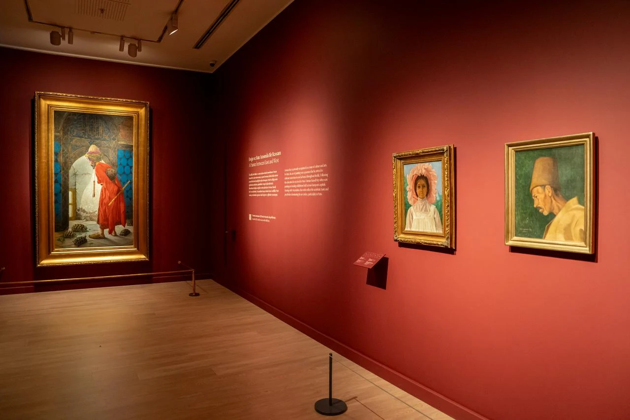 An installation view of the Osman Hamdi Bey gallery at Pera Museum, featuring The Tortoise Trainer alongside portraits by the artist. (Photo via Pera Museum)