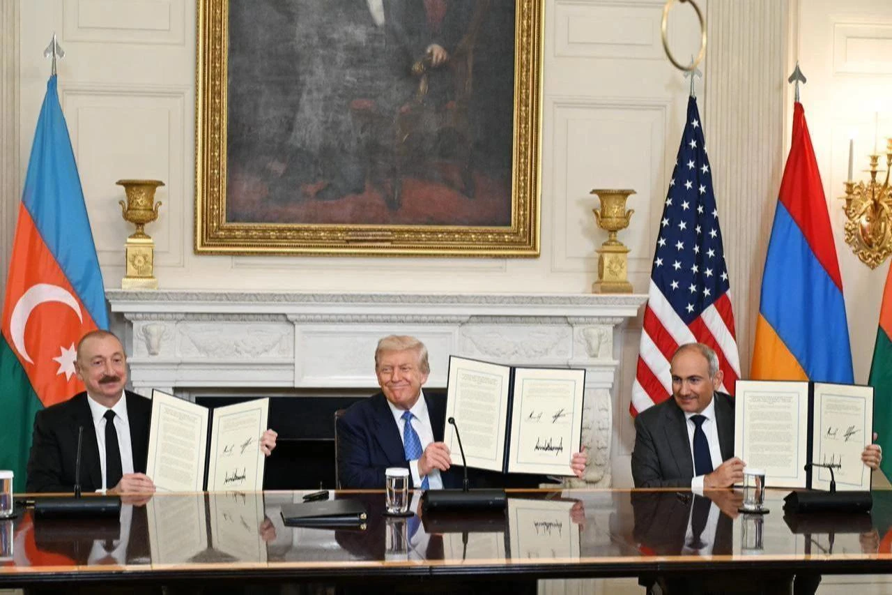 U.S. President Donald Trump (C), Azerbaijani President Ilham Aliyev (L), and Armenian Prime Minister Nikol Pashinyan (R) sign the joint declaration peace roadmap following their trilateral meeting at the White House in Washington, United States on Aug. 08, 2025. (Azerbaijan Presidency / AA Photo)