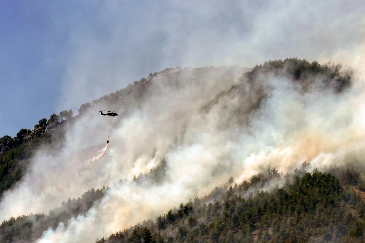 ANFire extinguishing efforts continue both from the air and land to contain a wildfire in the Alanya district of Mugla, Türkiye on July 30, 2026. (AA Photo)