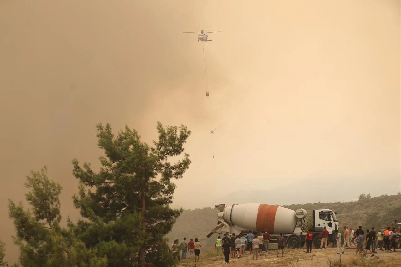 Firefighters respond from the air and ground to a forest fire in the Seydikemer district of Mugla, Türkiye on July 29, 2026. (AA Photo)