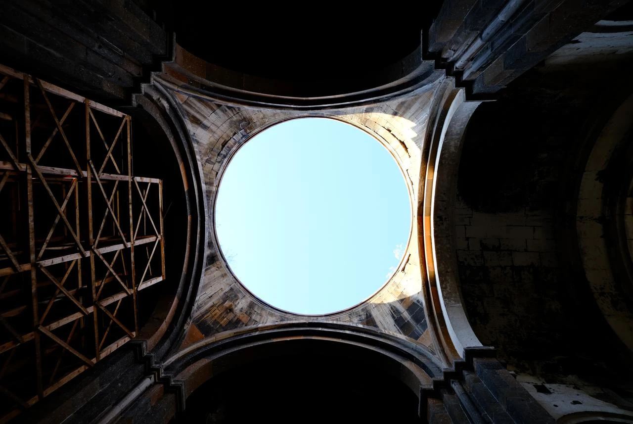 The open dome of the Cathedral of Ani, the site's largest surviving building, has let the sky through since its roof collapsed in the 1319 earthquake, on July 2026. (Yagiz Efe Parmaksiz / Türkiye Today)