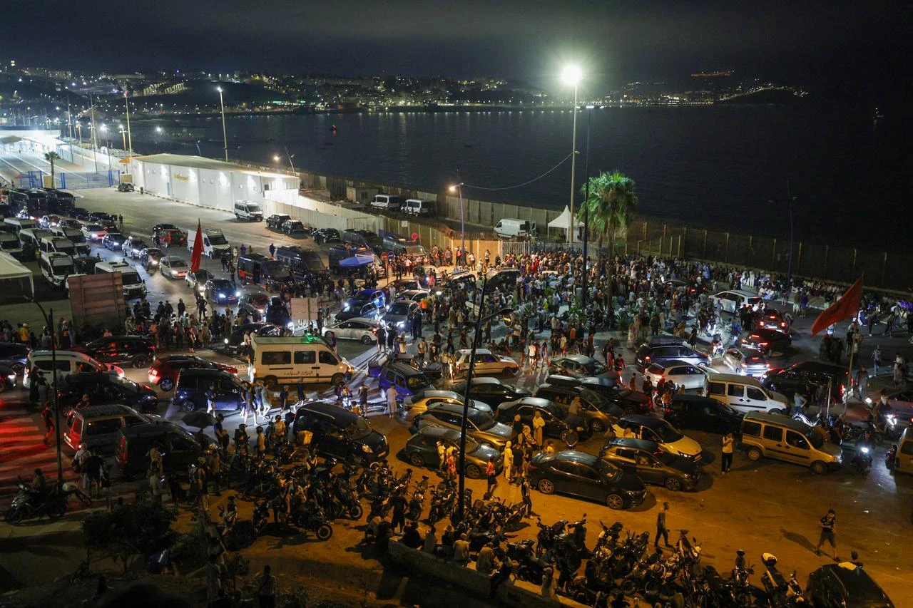 People gather at Bab Sebta, on the Morocco-Spain border near Spain's enclave of Ceuta and the Moroccan town of Fnideq, July 30, 2026. (AFP Photo)