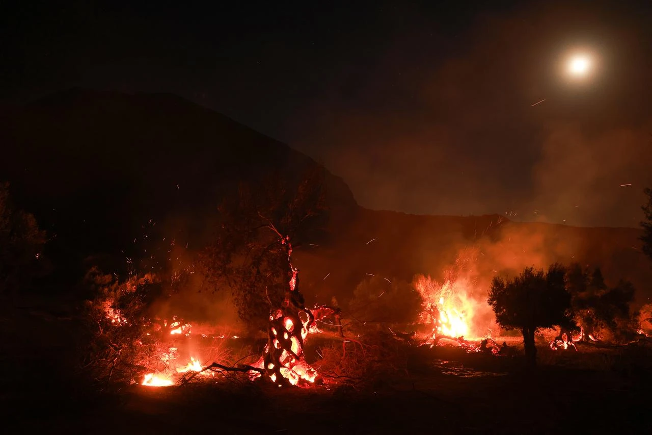 Firefighters battle a wildfire burning near the village of Preveli in the Rethymno region on the island of Crete, Greece, on July 30, 2026. (AA Photo)