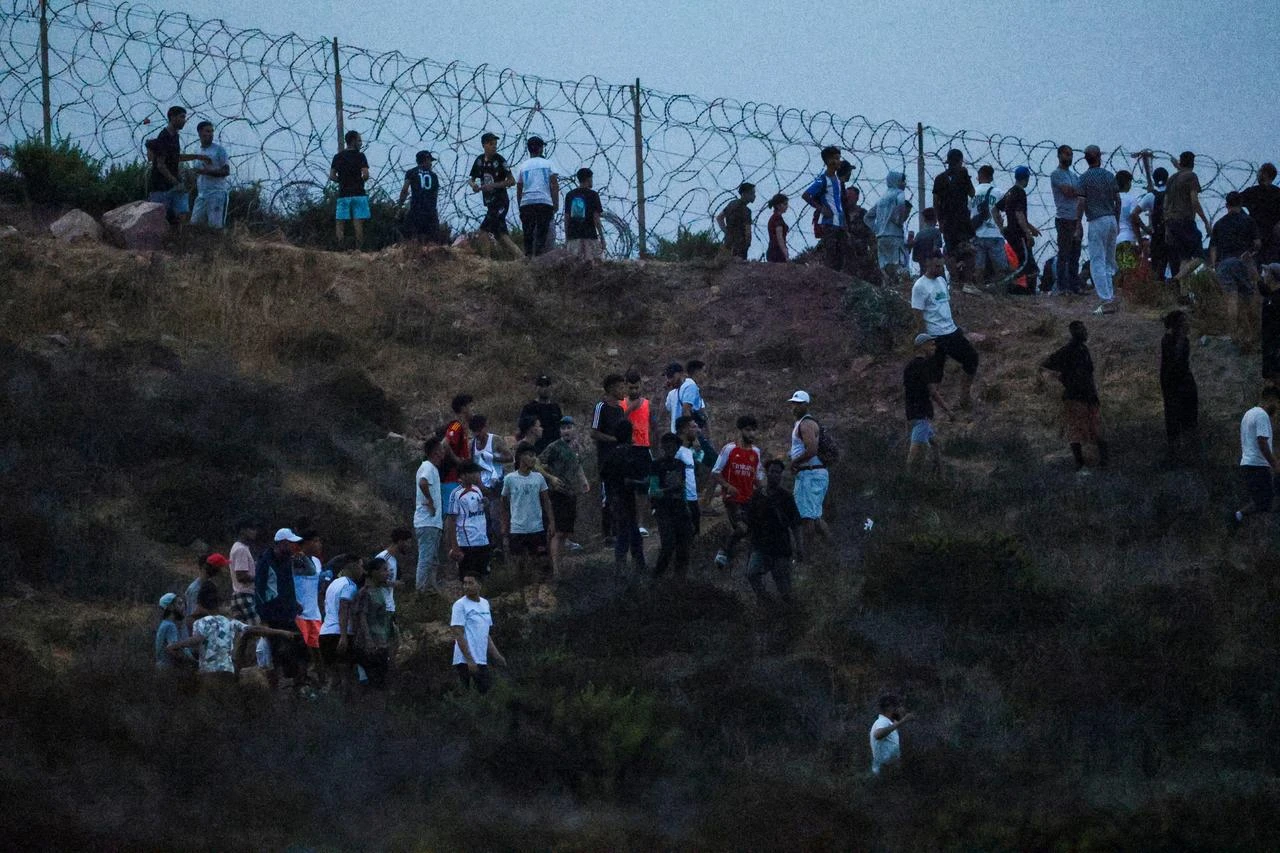 People gather on a hilltop near Bab Sebta on the Morocco-Spain border, near Spain's enclave of Ceuta and the Moroccan town of Fnideq, July 30, 2026. (AFP Photo)