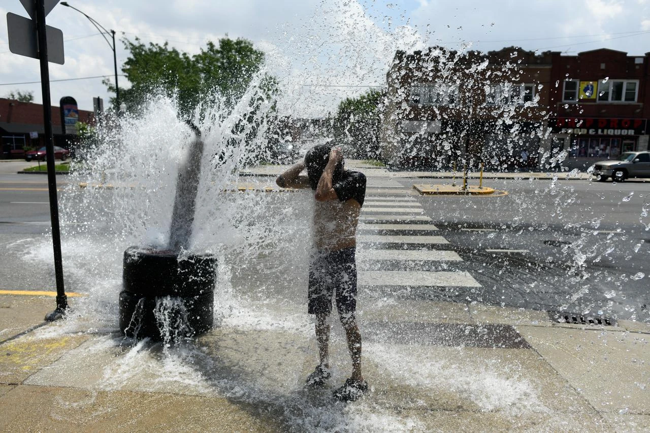 A person cools off with water from an open fire hydrant during a heat wave in Illinois, US, July 2, 2026. (AFP Photo)