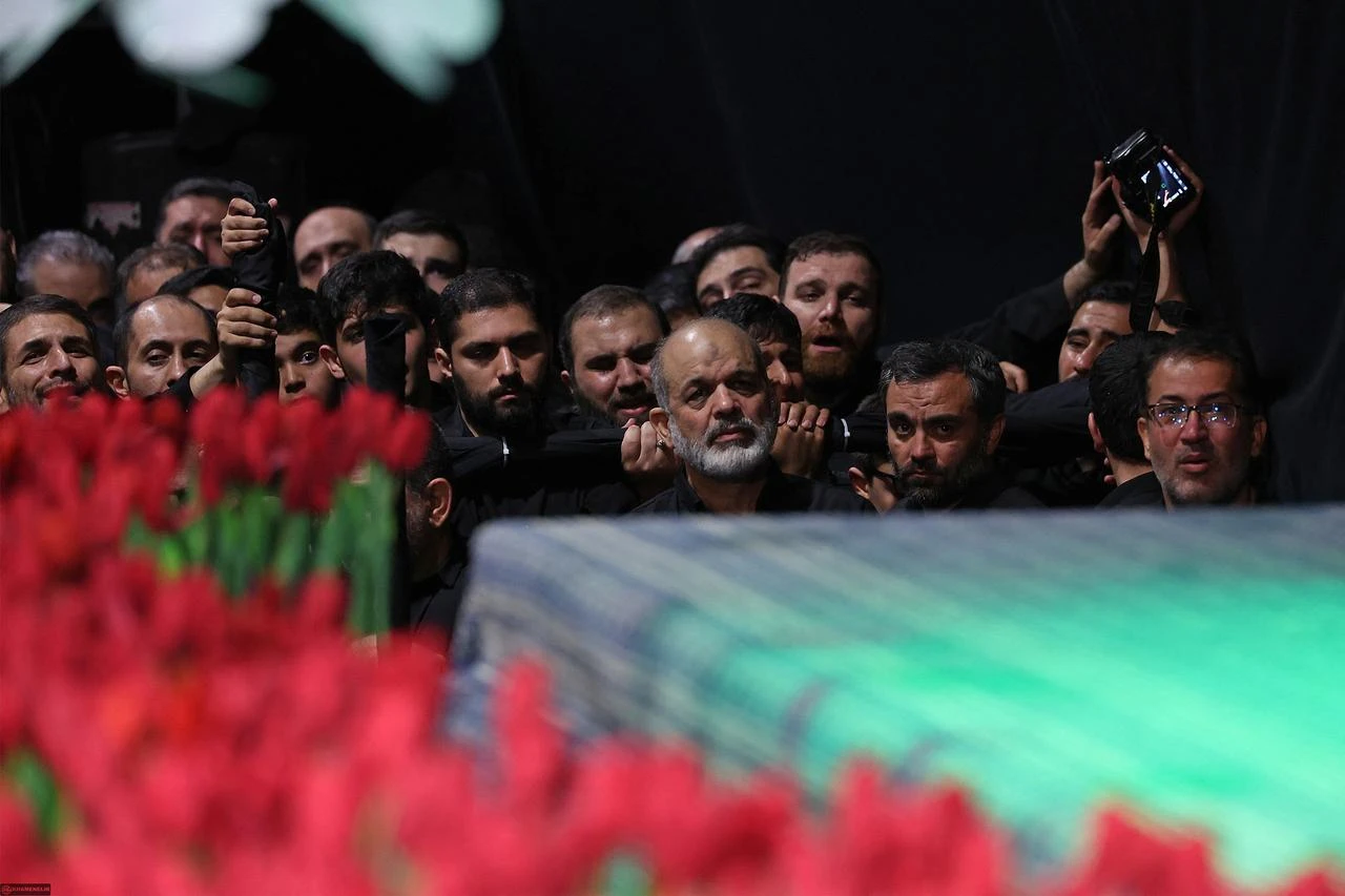 The chief of Iran's Revolutionary Guards, Ahmad Vahidi (C) paying respect at the coffin of Iran's slain supreme leader Ali Khamenei during a ceremony ahead of his funeral in Tehran, July 3, 2026. (Photo by Khamenei.IR/AFP)