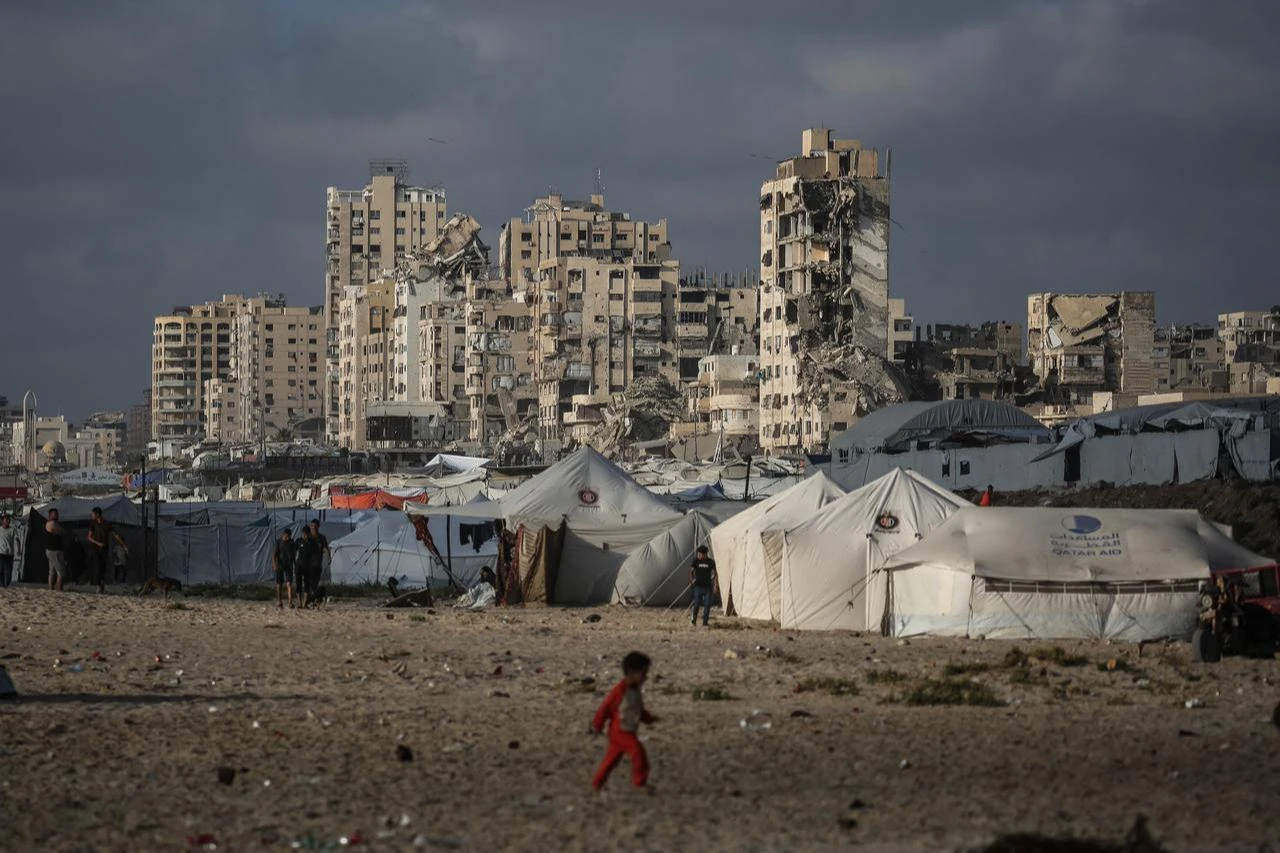 A Palestinian child walks near a camp for the displaced on the beach in Gaza City on July 3, 2026. (AFP Photo)