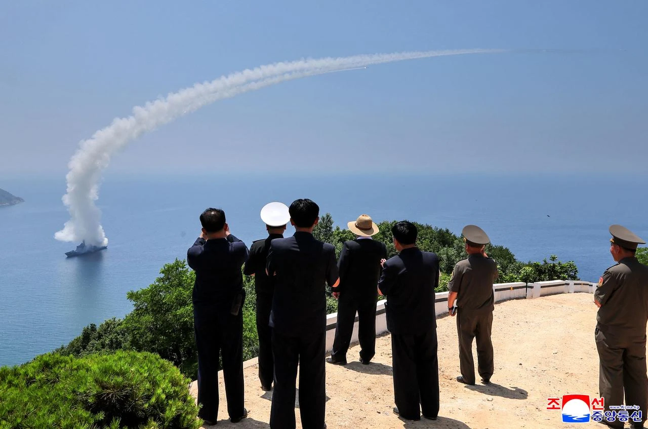 This picture taken on July 3, 2026 and released by North Korea's official Korean Central News Agency (KCNA) via KNS on July 5, 2026 shows North Korea's leader Kim Jong Un (C) observing performance tests of the main weapons systems of the destroyer Kang Kon at an undisclosed location in North Korea. (Photo by KCNA VIA KNS / AFP)