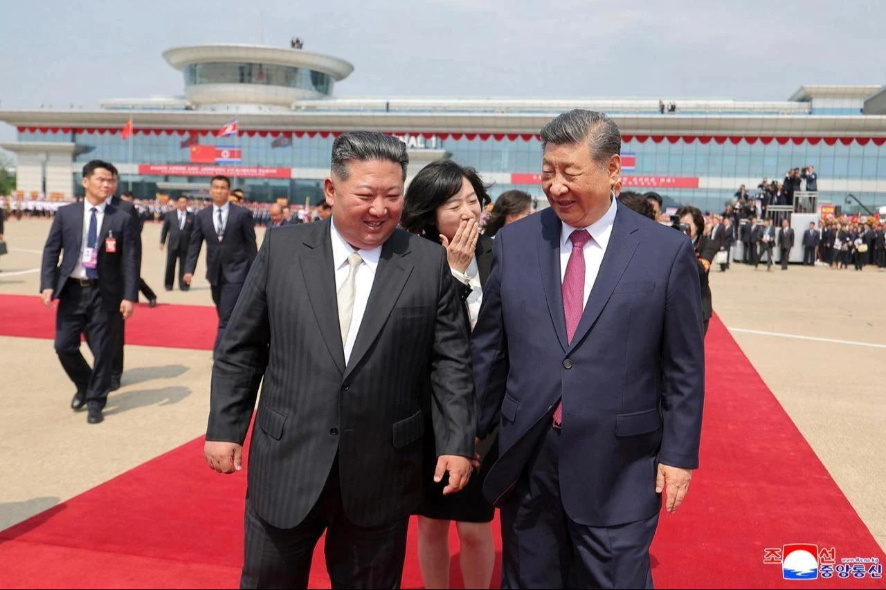 This picture taken on June 9, 2026 and released by North Korea's official Korean Central News Agency (KCNA) on June 10, 2026 shows North Korean leader Kim Jong Un (L) seeing off China's President Xi Jinping (R) during the latter's departure from Pyongyang International Airport. (Photo via KCNA/AFP)