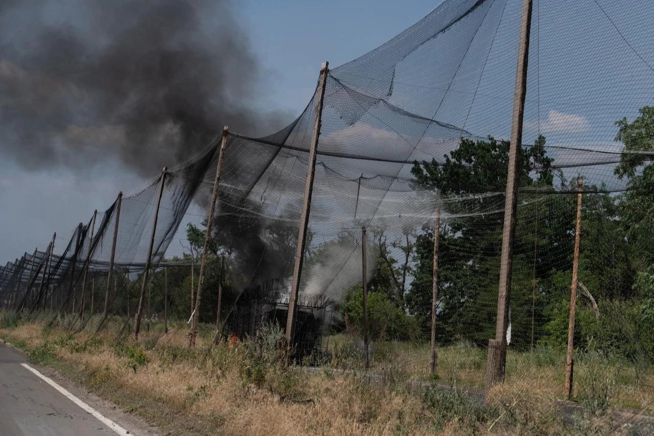 In this handout photograph taken on July 3, 2026 a military vehicle is on fire by anti-drone nets in Druzhkivka, Donetsk region. (Photo by Iryna Rybakova/The 93rd Kholodnyi Yar Separate Mechanized Brigade/AFP)