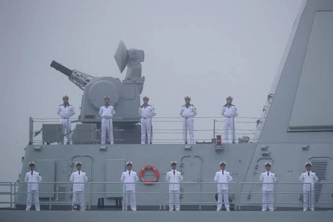 Sailors stand on the deck of the Type 055 guided-missile destroyer Nanchang as it participates in a parade on April 23, 2019. (AFP Photo)