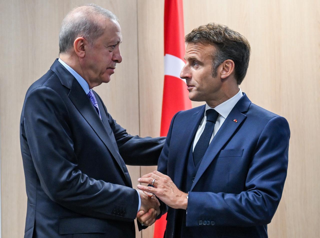 President Recep Tayyip Erdogan (L) greets French President Emmanuel Macron (R) as they meet within the NATO Heads of State and Government Summit in The Hague, Netherlands, June 25, 2025. (AA Photo)