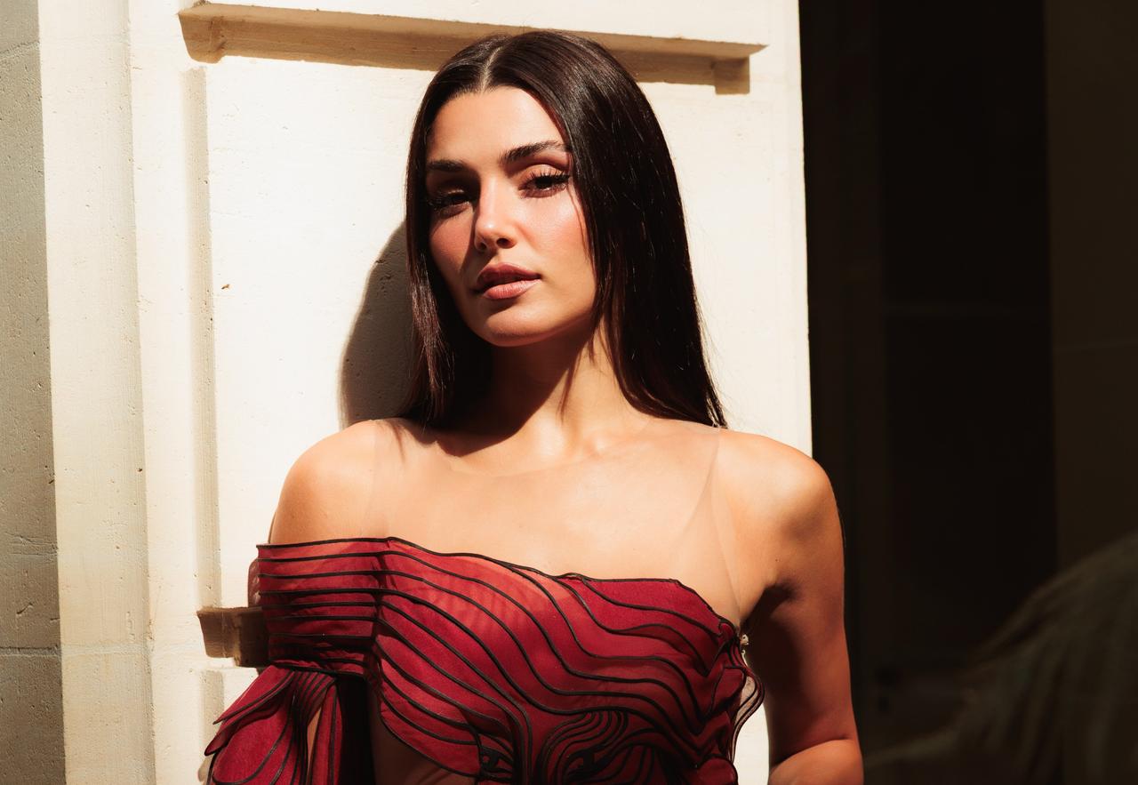 Turkish actress Hande Ercel poses in a red-and-black illusion-style dress during Paris Fashion Week, July 6, 2026. (Photo via Instagram/@handemiyy)