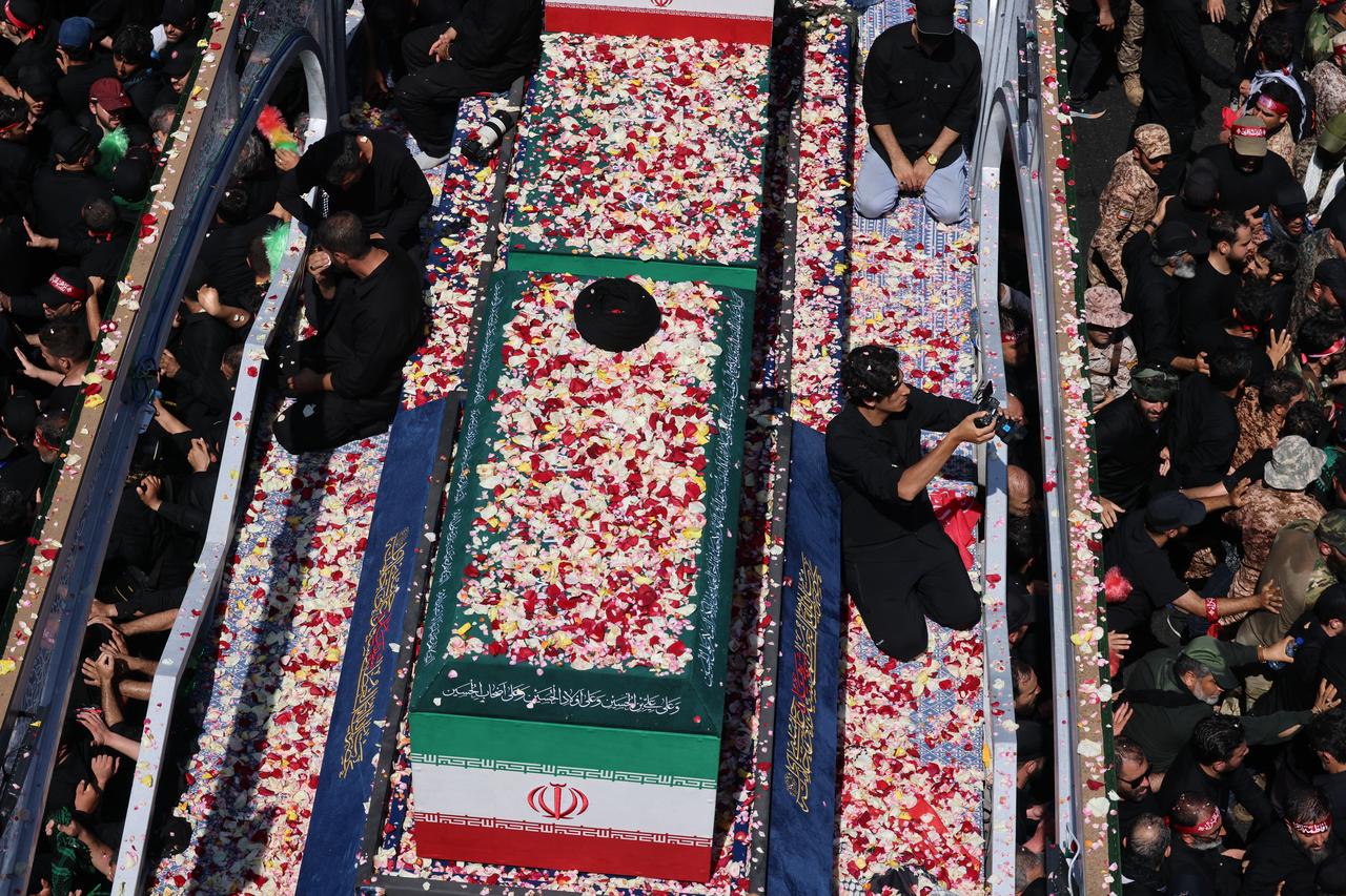 Flower petals are thrown on the coffin of Iran's slain Supreme Leader Ali Khamenei along a street during his funeral procession in Tehran, July 6, 2026. (AFP Photo)