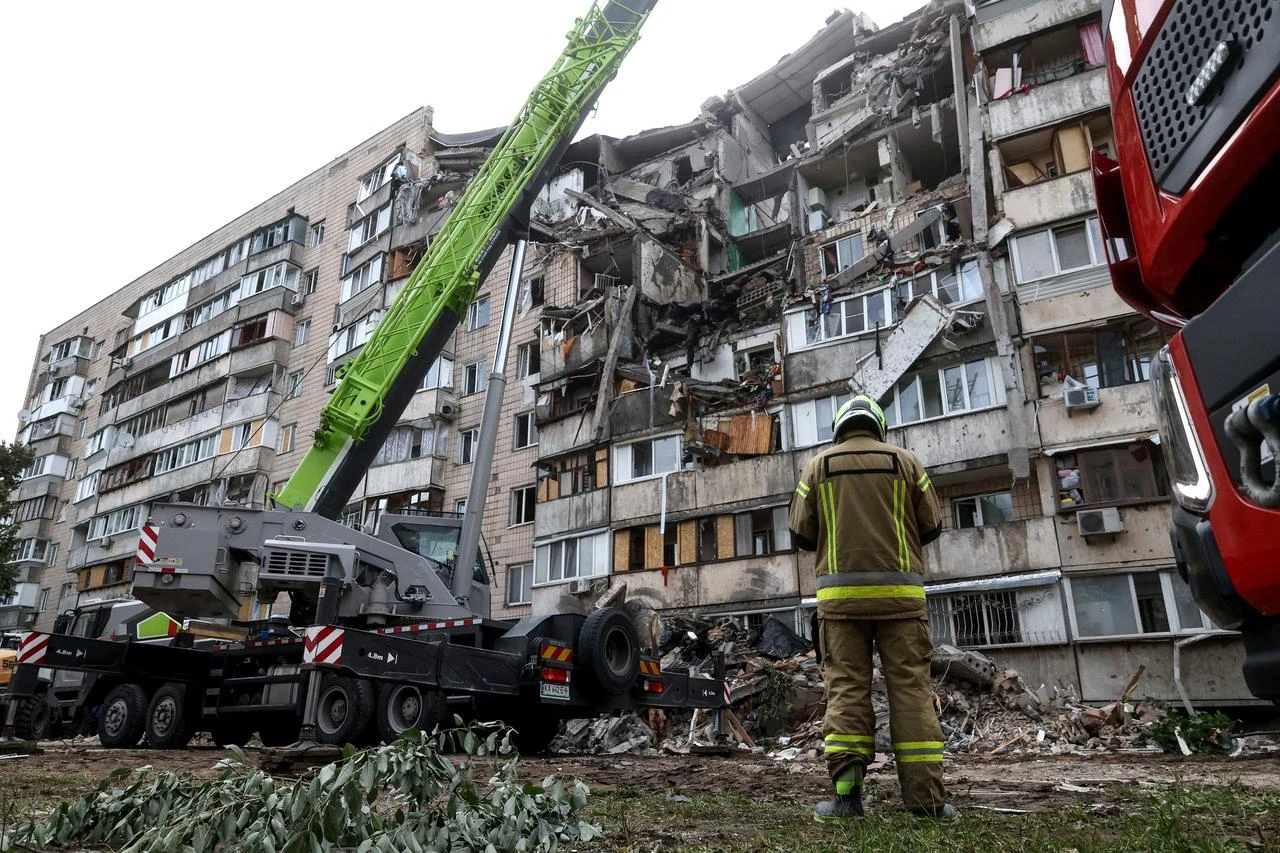 Rescuers work on a residential building partially destroyed as a result of Russian missile strike on the Ukrainian capital of Kyiv on July 6, 2026, amid the Russian invasion in Ukraine. (AFP Photo)