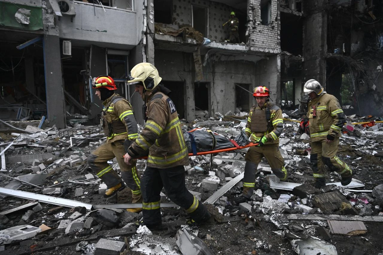 Rescuers carry the body of a local resident from a residential building damaged following a Russian missile strike on the Ukrainian capital of Kyiv on July 6, 2026, amid the Russian invasion in Ukraine. (AFP Photo)