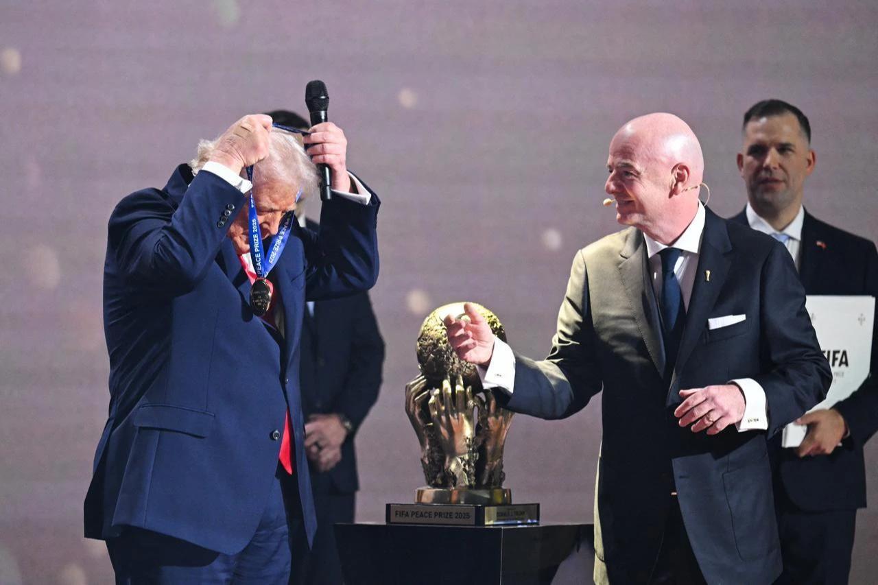 US President Donald Trump reacts as he receives the FIFA Peace Prize from Italian Fifa President Gianni Infantino during the draw for the 2026 FIFA Football World Cup taking place in the US, Canada and Mexico, at the Kennedy Center, in Washington, DC, on Dec. 5, 2025. (AFP Photo)