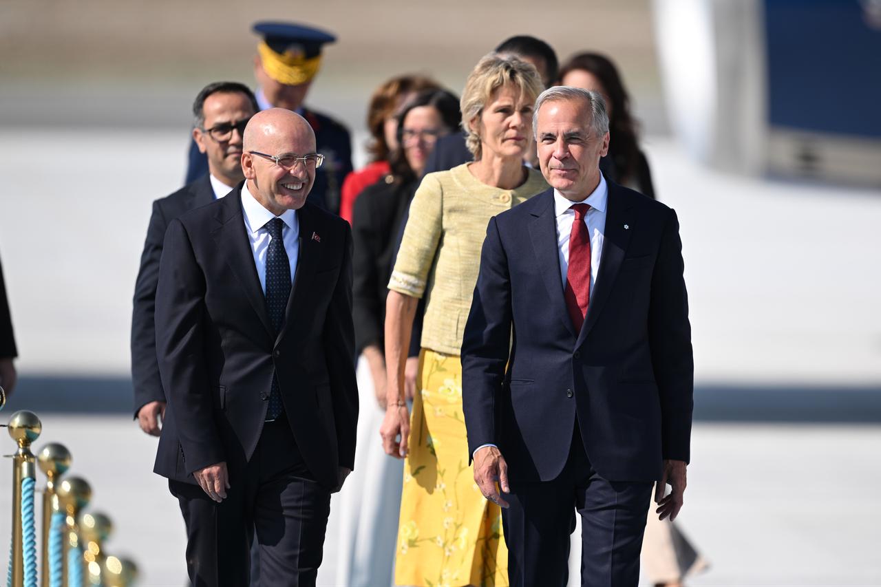 Canadian Prime Minister Mark Carney (R) is welcomed by Turkish Treasury and Finance Minister Mehmet Simsek (L) upon his arrival at Ankara Airport to attend the 36th NATO Heads of State and Government Summit in Ankara, Türkiye, July 07, 2026. (AA Photo)