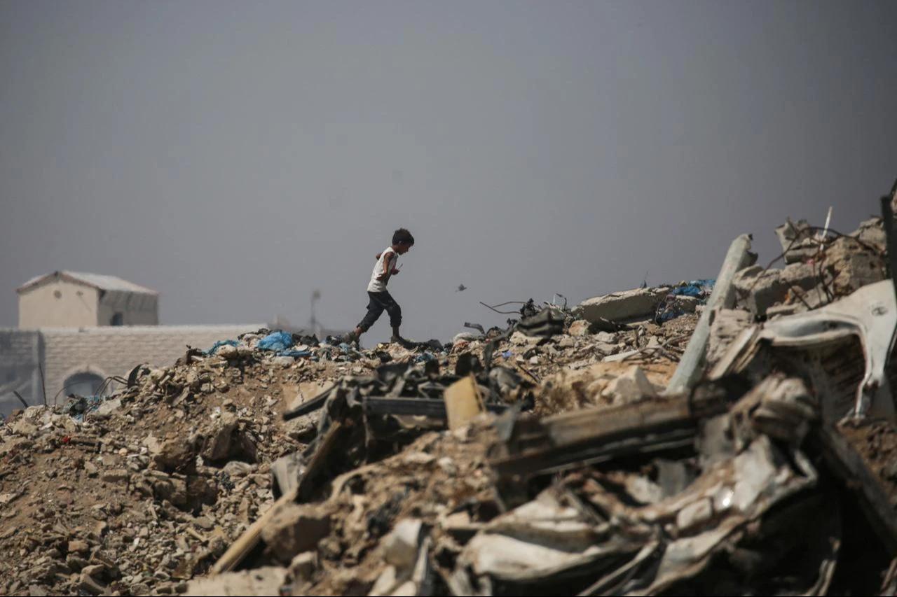 A Palestinian boy makes his way across rubble near a displacement camp in Nuseirat, in the central Gaza Strip, June 28, 2026. (AFP Photo)