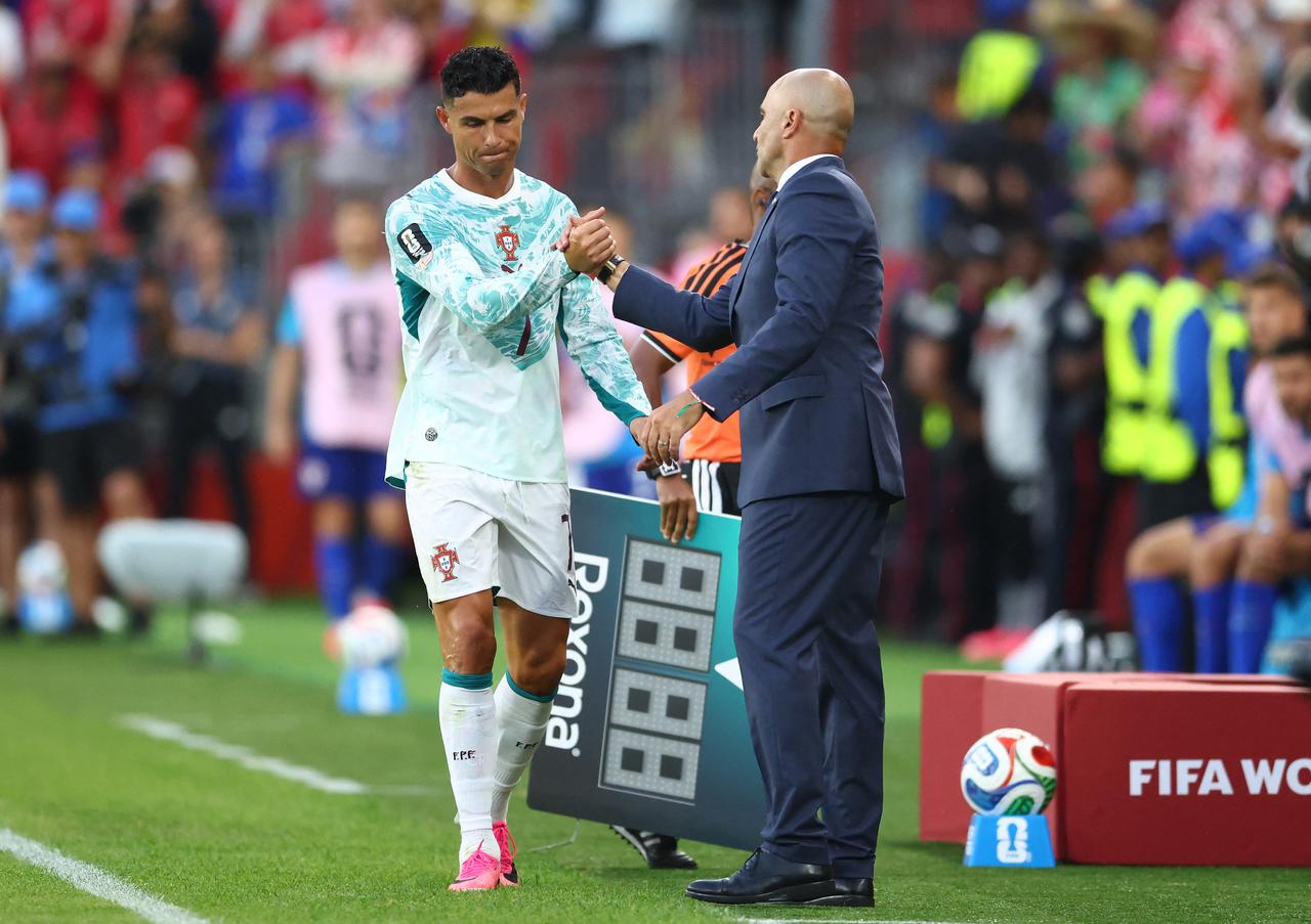 Portugal's forward #07 Cristiano Ronaldo is greeted by his Spanish head coach Roberto Martinez after being substituted during the 2026 World Cup round of 32 football match between Portugal and Croatia at the Toronto Stadium in Toronto on July 2, 2026. (AFP Photo)