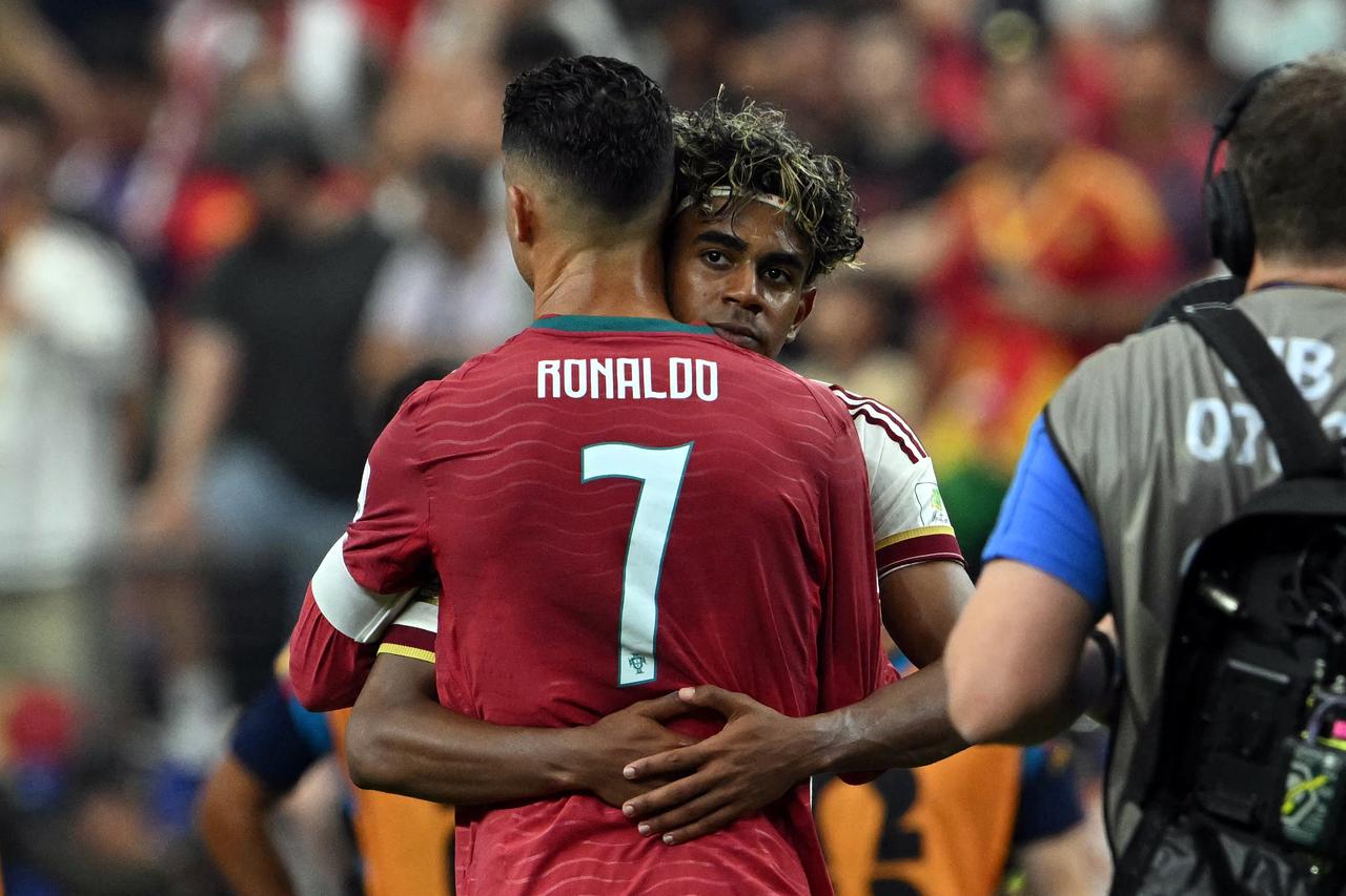 Portugal's forward #07 Cristiano Ronaldo and Spain's forward #19 Lamine Yamal embrace each other after the 2026 World Cup between Portugal and Spain at the Dallas Stadium in Texas, US, July 6, 2026. (AFP Photo)