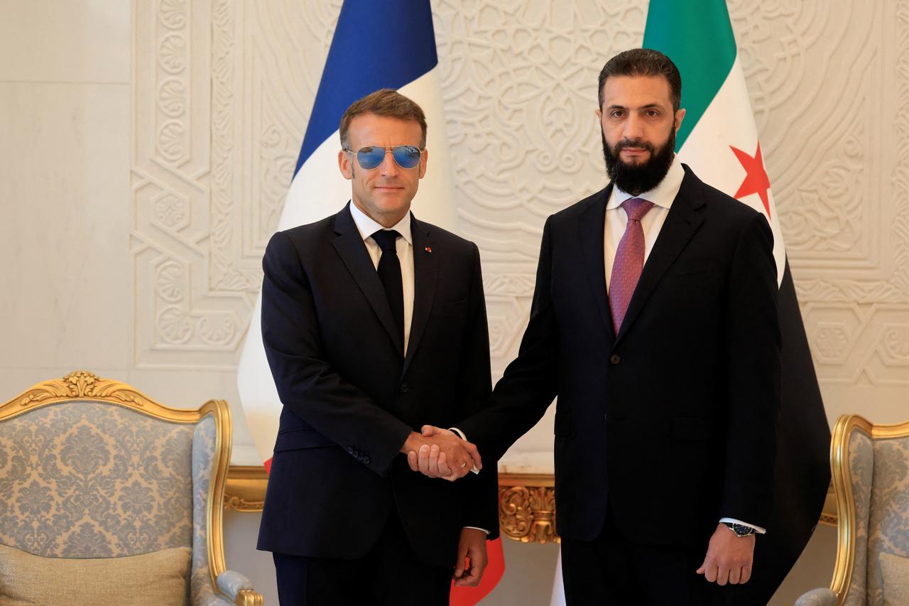 Syria's President Ahmed al-Sharaa (R) shakes hands with France's President Emmanuel Macron ahead of their meeting at the People's Palace in Damascus, Syria, July 7, 2026. (AFP Photo)