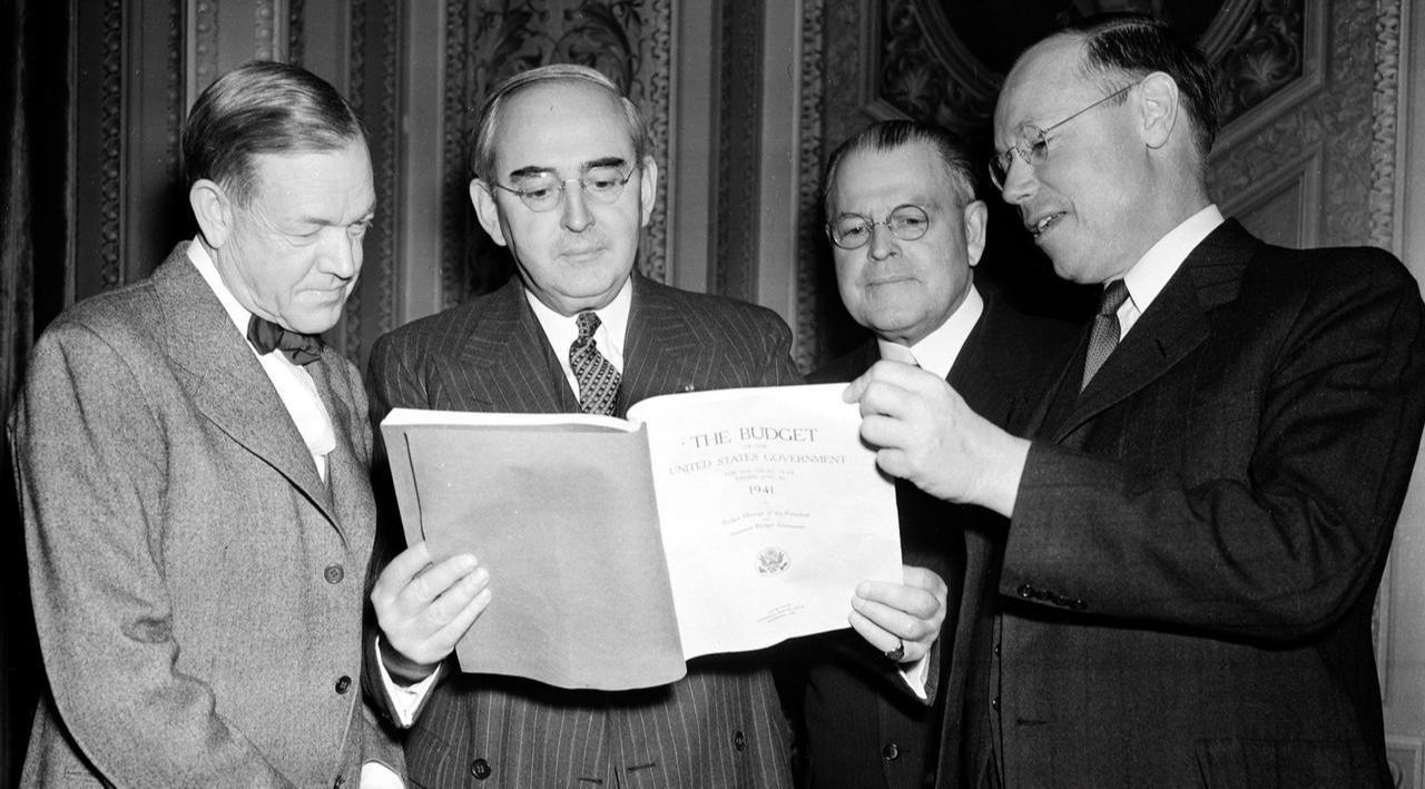 This historical photograph shows Republican Senators Charles McNary, Arthur Vandenberg, Warren Austin, and Robert A. Taft examining President Franklin D. Roosevelt's budget message on January 4, 1940. (via Vandenberg Coalition)