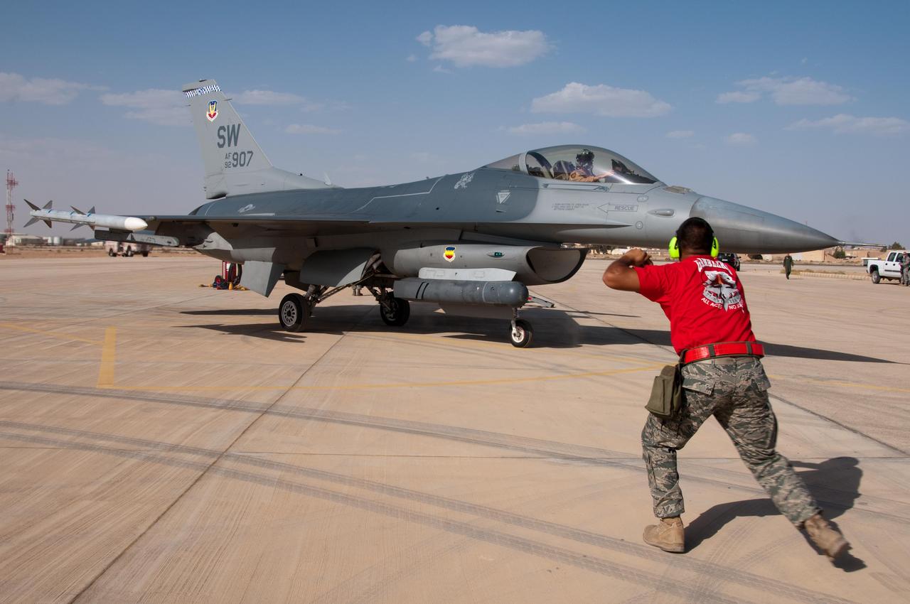 U.S. Air Force Staff marshals F-16 Fighting Falcon as it prepares for takeoff during the Alert Scramble competition at the 2010 Falcon Air Meet, Oct. 20, 2010, Muwaffaq Salti Air Base, Azraq, Jordan. (Photo via U.S. Air Force)