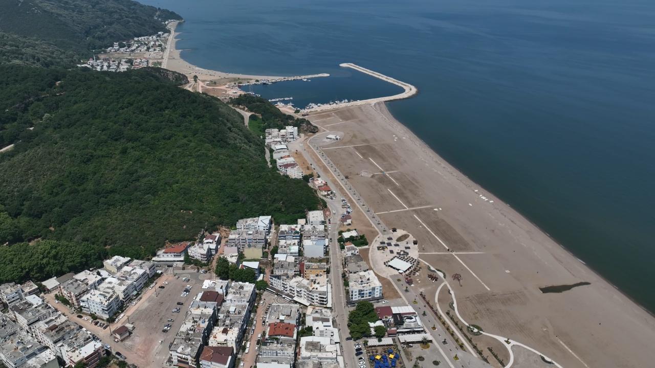 An aerial view shows a beach, marina and coastal settlement along Bursa's Karacabey shoreline, one of Türkiye's longest uninterrupted beach areas, July 8, 2026. (IHA Photo)