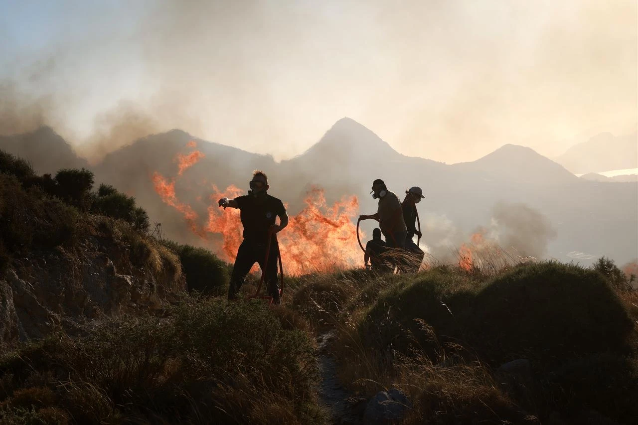 Firefighters battle a wildfire burning near the village of Drimiskos in the Rethymno region on the island of Crete, Greece, on July 31, 2026. (AA Photo)