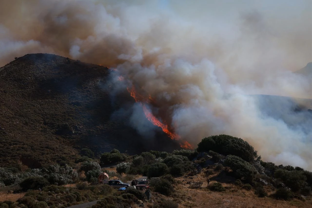 Firefighters battle a wildfire burning near the village of Drimiskos in the Rethymno region on the island of Crete, Greece, on July 31, 2026. (AA Photo)
