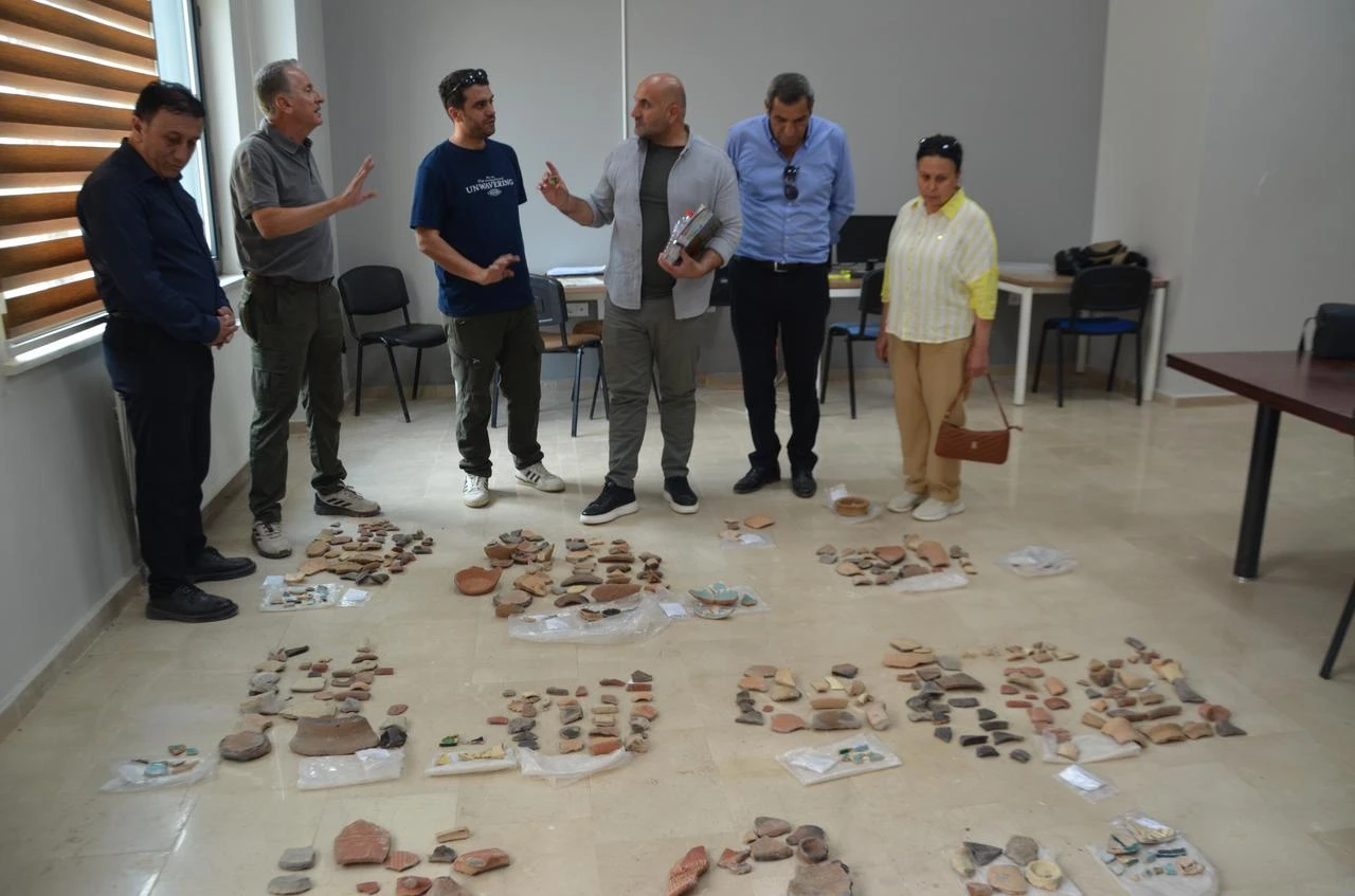 Researchers examine archaeological finds recovered during excavations and surface surveys in Malazgirt. (AA Photo)