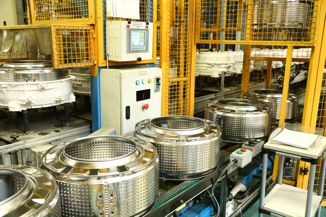 Washing machine drums move along a production line at a white goods manufacturing facility in Türkiye. (Adobe Stock Photo)