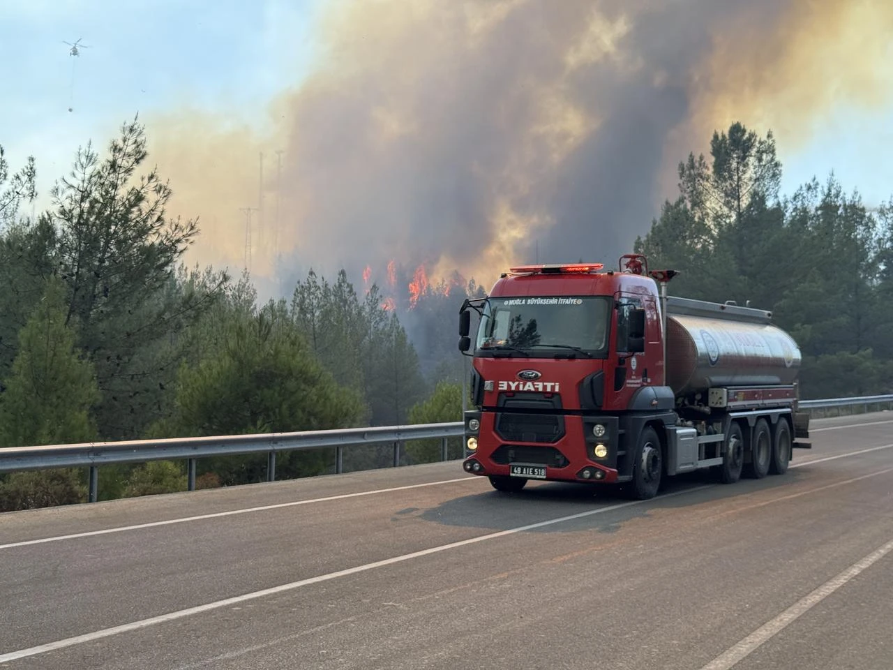 Smoke from the fire area fills the sky while firefighters and Turkish General Directorate of Forestry teams continue their efforts by air and land to extinguish the fire that broke out in the forest area in Fethiye district of Mugla, Türkiye on July 31, 2026. (AA Photo)