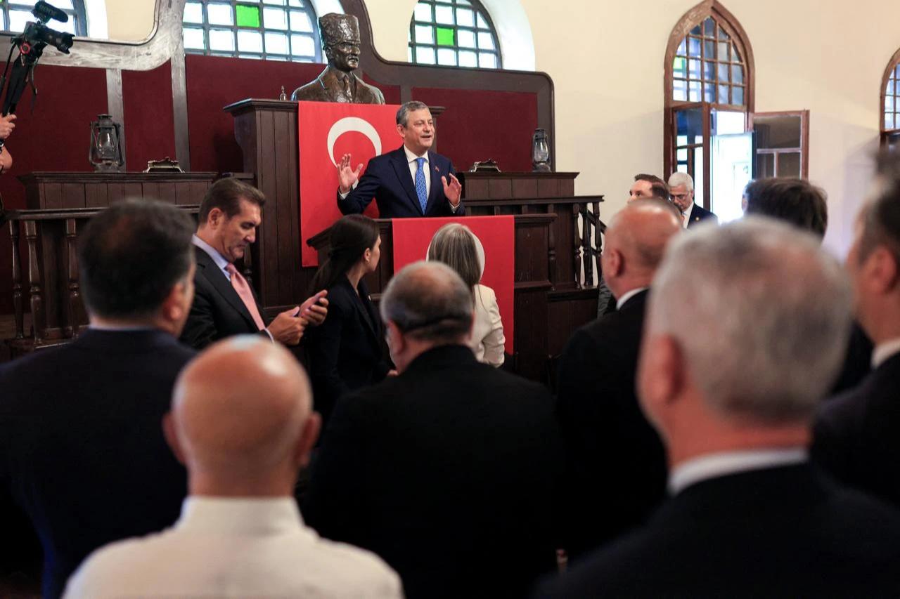 This handout photograph taken and released by the Yeni Party (New Party) press office on July 24, 2026, shows Yeni Party (new party) leader Ozgur Ozel (C) delivering a speech from the historical First Grand National Assembly of Türkiye, to the 91 members of parliament who have resigned from the Republican People's Party (CHP) and joined the Yeni Party in Ankara. (Ozgur Ozel Press Office/AFP Photo)