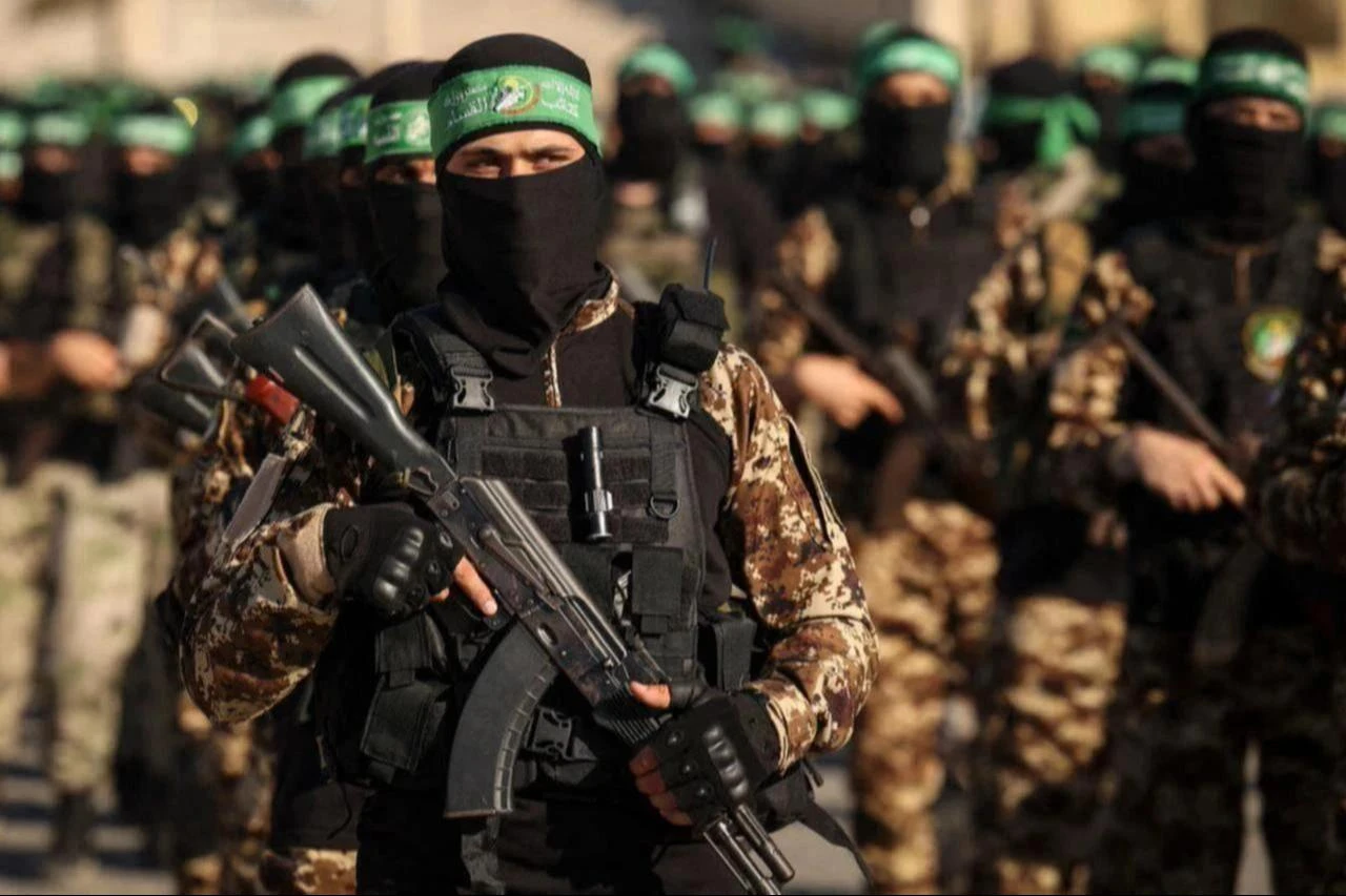 Masked members of the military wing of Hamas march during a rally in Gaza City, July 20, 2022. (AFP Photo)
