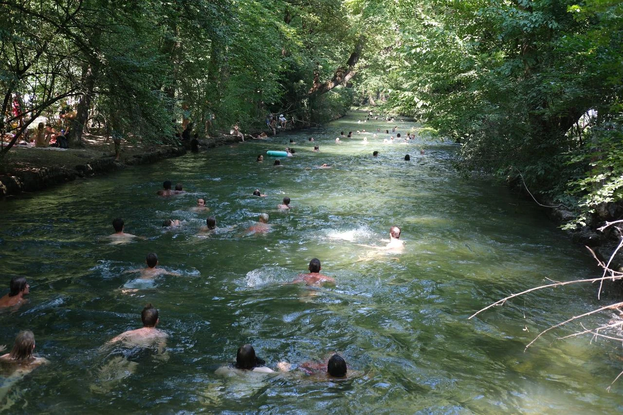 People swim in the Eisbach River to cool off during record summer heat in Munich, Germany, July 31, 2026. (AA Photo)