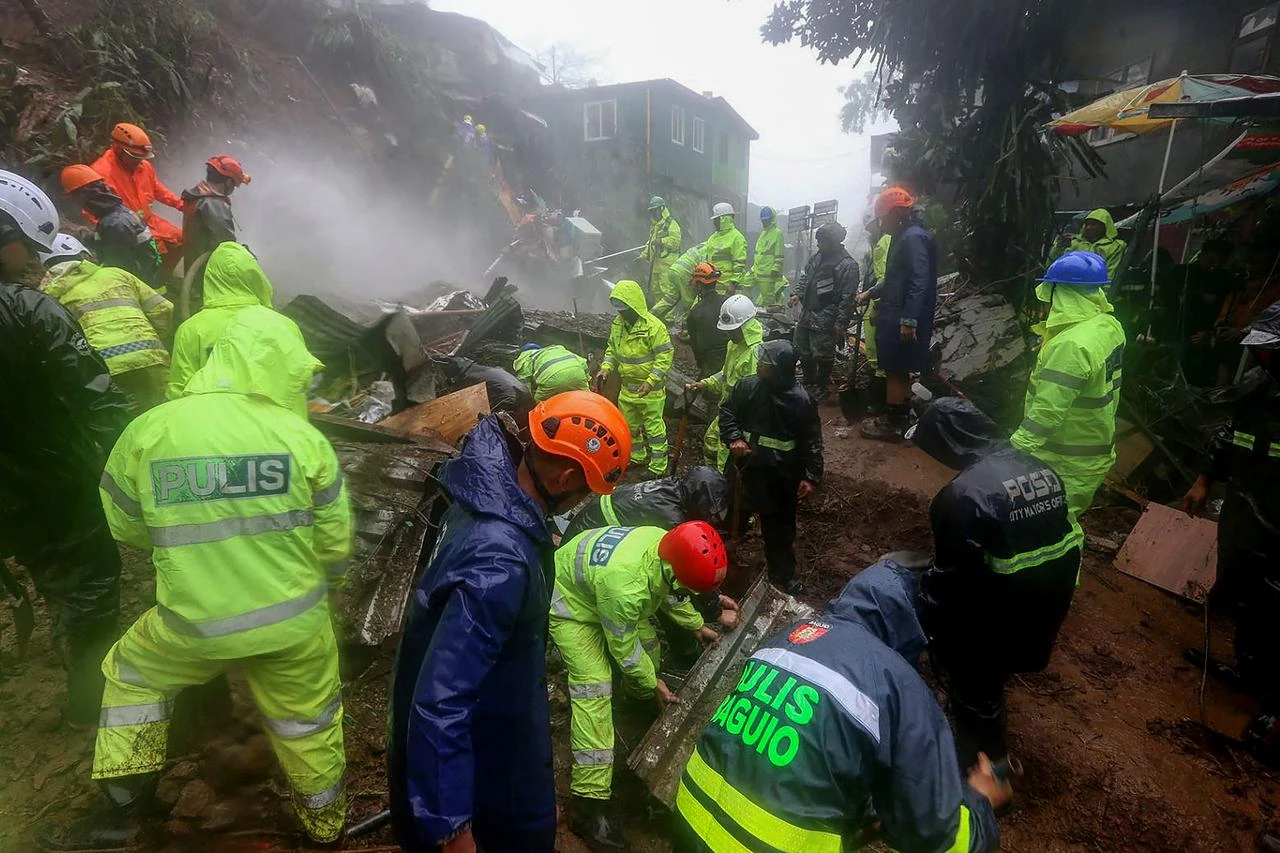 Rescuers sift through rubble as they search for survivors after a rain-drenched mountainside collapsed on several houses in Baguio City, north of Manila, on August 10, 2026. (AFP Photo)