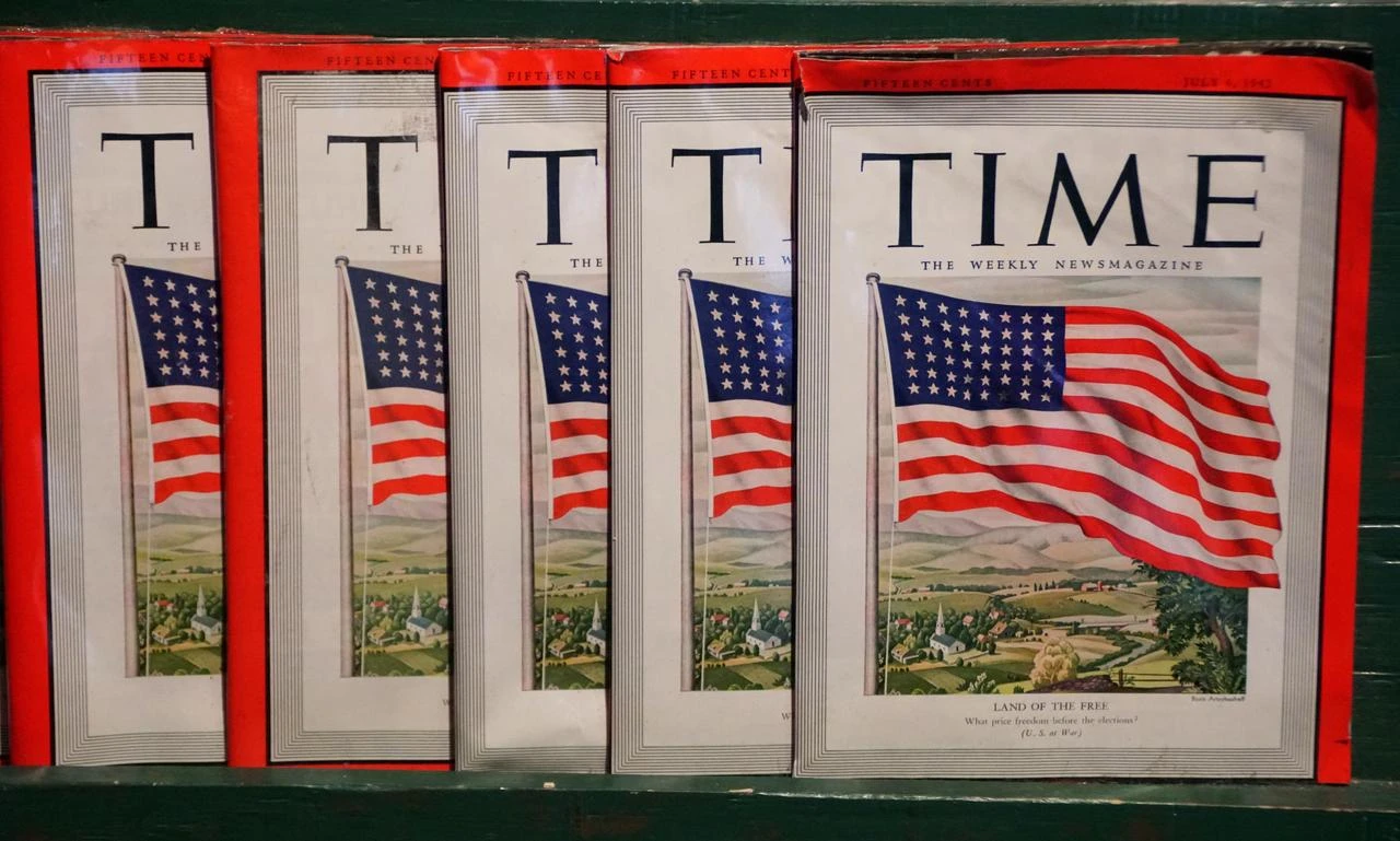 Vintage copies of TIME magazine featuring a U.S. flag-themed cover are displayed, including an issue dated July 6, 1942. (Adobe Stock Photo)