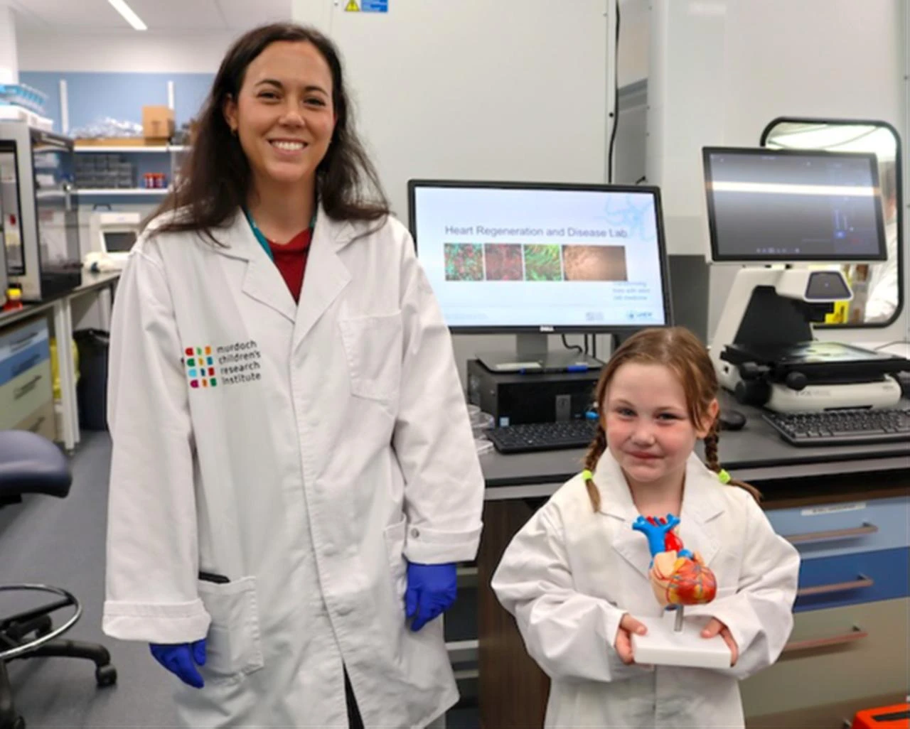 Patient Emily, 7, with Dr Holly Voges posing with a heart-shaped structure. (Photo via mcri.edu.au)