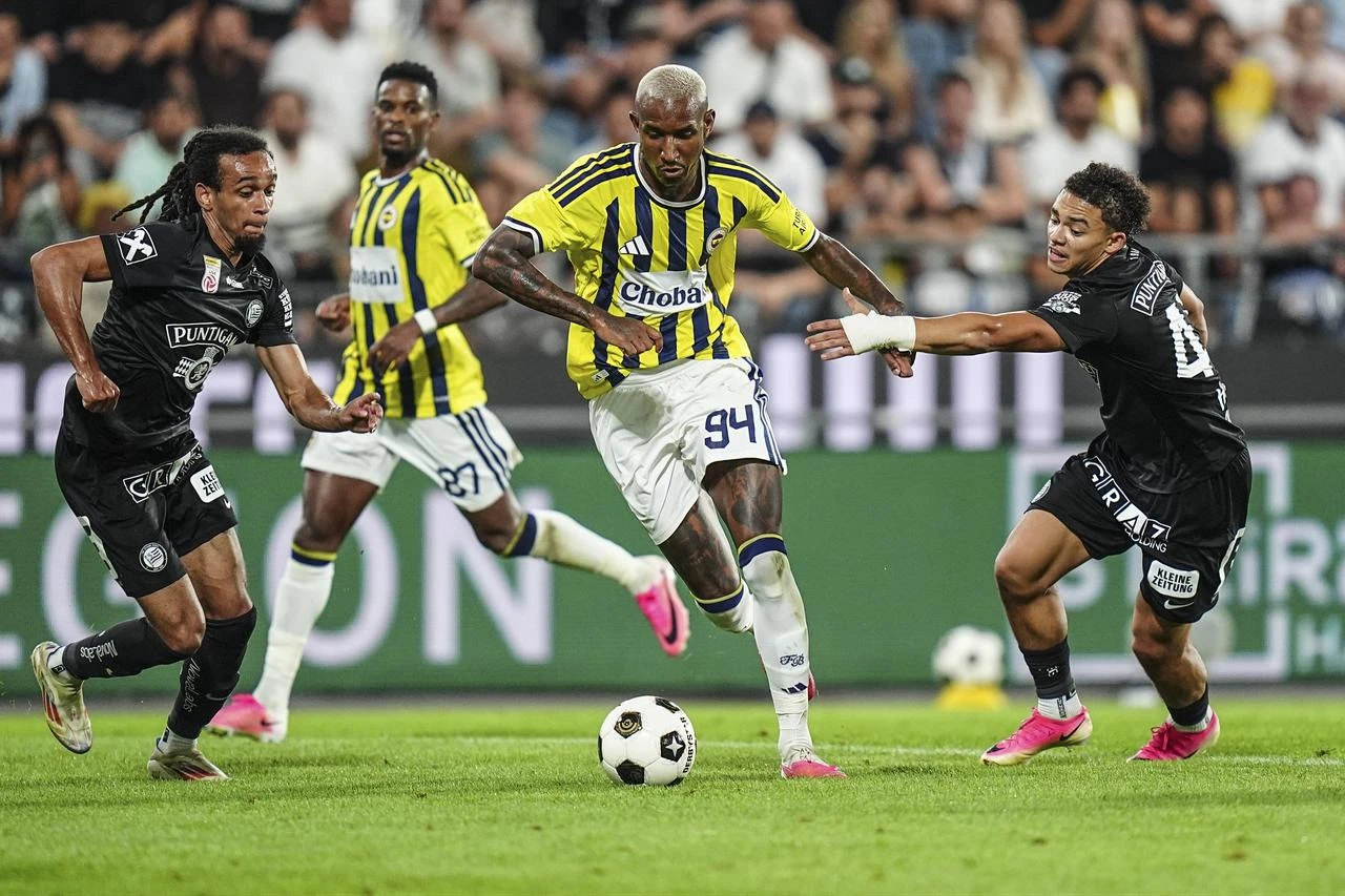 Jacob Peter Hodl (R) of Sturm Graz in action against Anderson Talisca (94) of Fenerbahce during the UEFA Champions League third qualifying round second-leg match between Sturm Graz and Fenerbahce at Liebenau Stadium in Graz, Austria on August 11, 2026. (AA Photo)