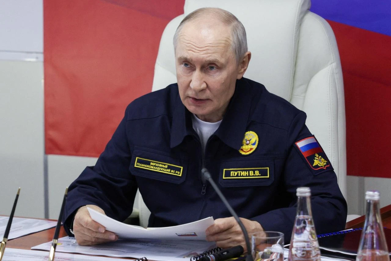 In this pool photograph distributed by the Russian state agency Sputnik, Russia's President Vladimir Putin holds a meeting onboard the Russian Navy's guided missile cruiser Varyag during the final stage of a Pacific Fleet's naval drills on far eastern Sakhalin Island on August 12, 2026. (Photo by Gavriil Grigorov / POOL / AFP)