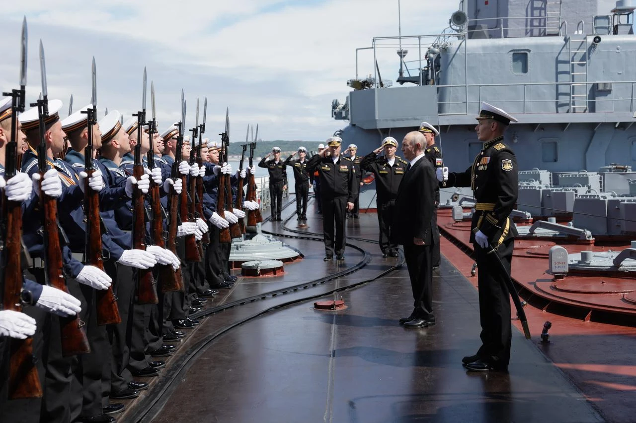 In this pool photograph distributed by the Russian state agency Sputnik, Russia's President Vladimir Putin visits the Russian Navy's guided missile cruiser Varyag as he oversees the final stage of a Pacific Fleet's naval drills on far eastern Sakhalin Island on August 12, 2026. (Photo by Gavriil Grigorov / POOL / AFP)