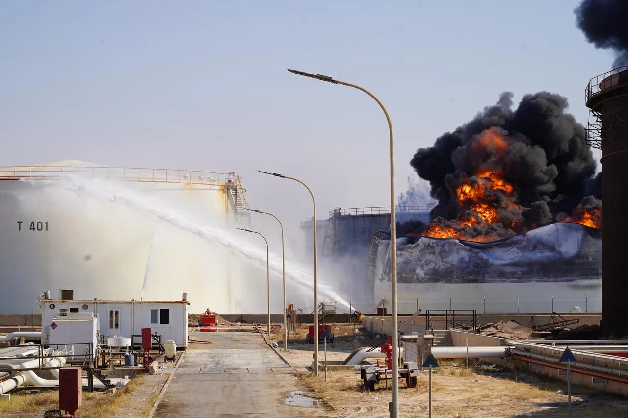 Firefighters work to extinguish a blaze inside a diesel tank following an attack at the Zawiya Oil Complex, west of Tripoli, Libya on August 11, 2026. (AA Photo)