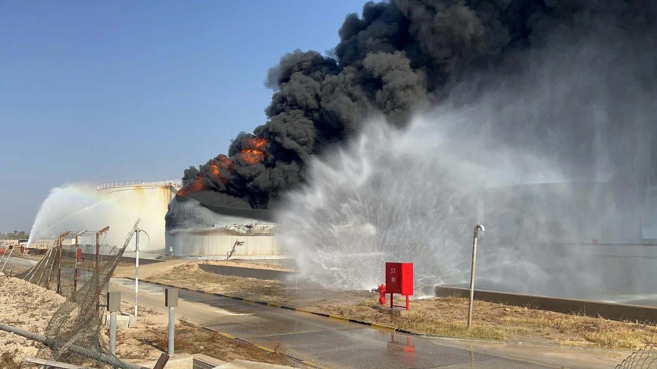 Firefighters work to extinguish a blaze inside a diesel tank following an attack at the Zawiya Oil Complex, west of Tripoli, Libya on August 11, 2026. (AA Photo)